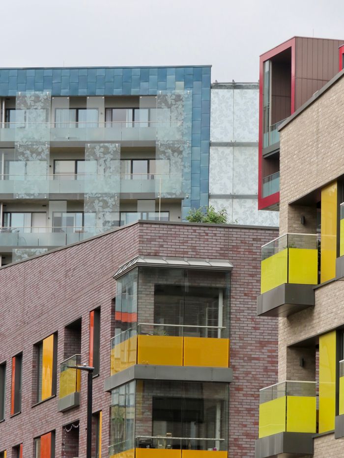 home-services-03 Contemporary architecture of colorful apartment buildings in a city setting.